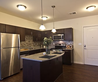 kitchen with a center island, stainless steel appliances, range oven, dark hardwood flooring, pendant lighting, dark brown cabinetry, and light countertops, Torrente at Upper St. Clair
