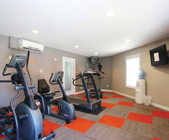 exercise room featuring natural light, TV, and a wall mounted air conditioner, Villa West Apartments