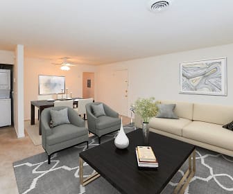carpeted living room featuring a ceiling fan and washer / dryer, Woodcrest Apartment Homes