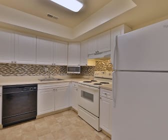 kitchen with ventilation hood, refrigerator, electric range oven, dishwasher, white cabinetry, light countertops, and light tile flooring, St. Mary's Landing Apartments and Townhomes