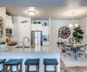 kitchen with stainless steel appliances, range oven, white cabinetry, light floors, and light granite-like countertops, The Station at Gateway