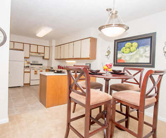 carpeted dining area with refrigerator, range oven, and exhaust hood, River Park Tower Apartment Homes