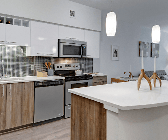 kitchen featuring a ceiling fan, a center island, electric range oven, stainless steel appliances, white cabinets, light countertops, pendant lighting, and light parquet floors, Tessera Apartments