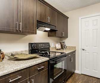 kitchen with stainless steel finishes, electric range oven, exhaust hood, dark brown cabinetry, dark parquet floors, and light granite-like countertops, Tuscany Pointe at Somerset Apartment Homes