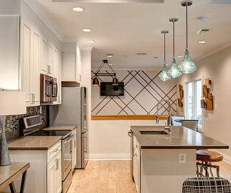 kitchen featuring natural light, electric range oven, microwave, refrigerator, white cabinets, pendant lighting, and light parquet floors, Lakeside