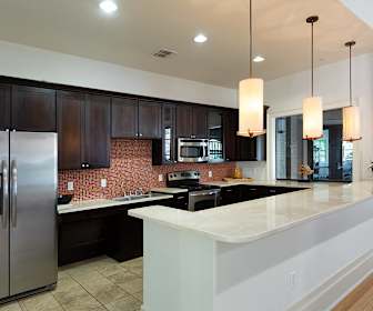 kitchen featuring electric cooktop, stainless steel appliances, light tile floors, dark brown cabinets, light countertops, and pendant lighting, DeLayne at Twin Creeks