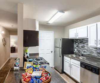 kitchen featuring TV, refrigerator, stainless steel dishwasher, white cabinets, dark parquet floors, and dark granite-like countertops, Grand Biscayne Apartments