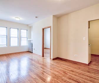 spare room with hardwood floors, natural light, and radiator, 7100 N. Sheridan Apartments