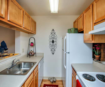 kitchen with ventilation hood, refrigerator, dishwasher, light flooring, light countertops, and brown cabinets, Pavilions at Pantano
