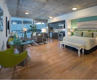 hardwood floored bedroom featuring natural light, range oven, and microwave, SkyHouse Channelside