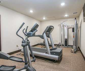 exercise room featuring carpet and TV, Zander Place Apartments