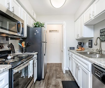 kitchen with stainless steel microwave, refrigerator, electric range oven, dishwasher, white cabinets, light granite-like countertops, and dark hardwood floors, Graymere