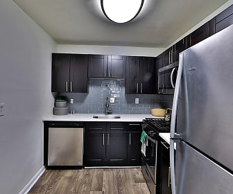 kitchen with stainless steel appliances, range oven, dark parquet floors, light countertops, and dark brown cabinets, Willow Run at Mark Center